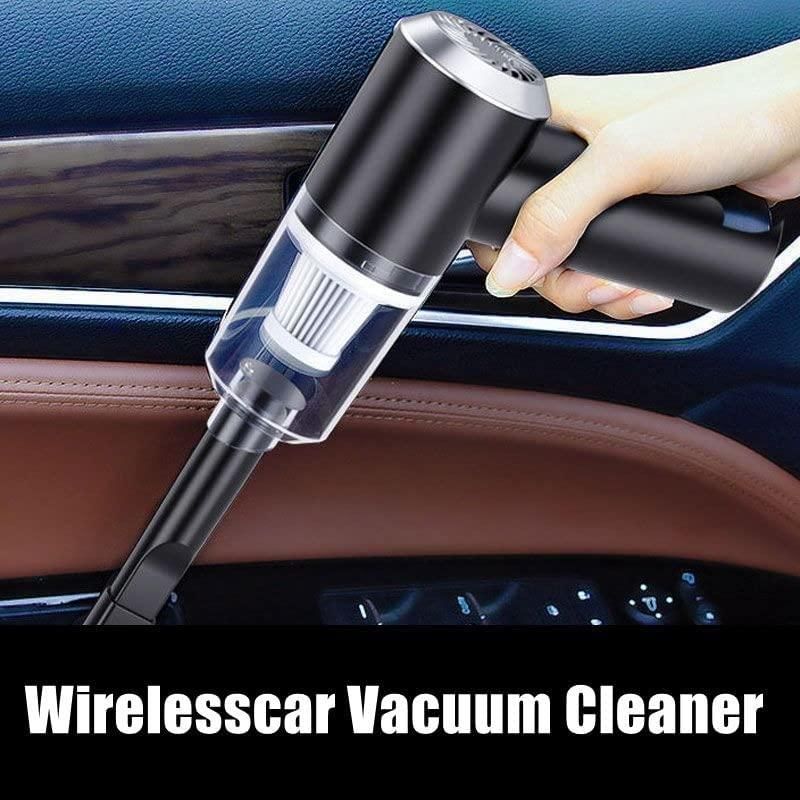 Hand holding a wireless vacuum cleaner on a car. 